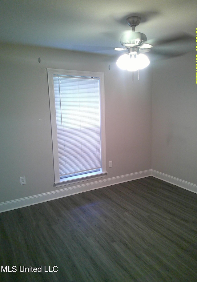 spare room with ceiling fan and dark hardwood / wood-style flooring