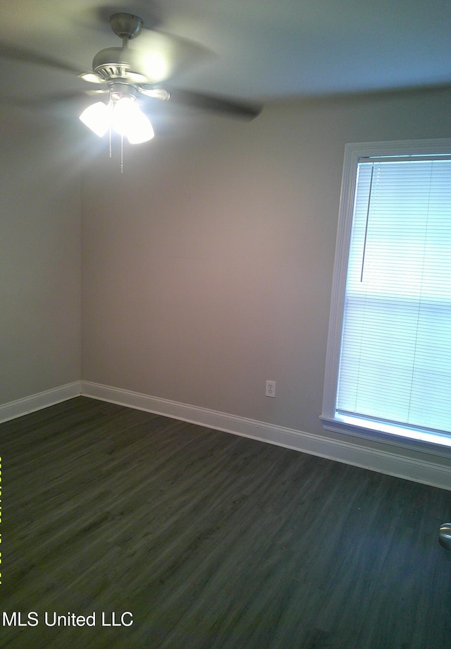 unfurnished room featuring ceiling fan and dark hardwood / wood-style floors