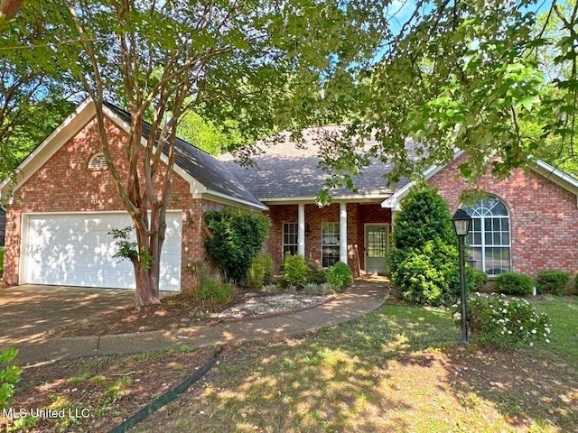 104 Warrior Ln, Clinton, MS 39056 - view of front of house with brick siding, driveway, an attached garage, and roof with shingles