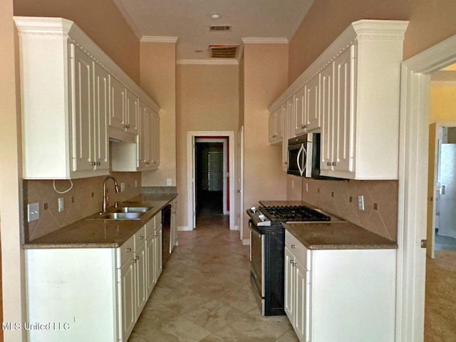 104 Warrior Ln, Clinton, MS 39056 - kitchen featuring appliances with stainless steel finishes, a sink, ornamental molding, tasteful backsplash, and white cabinets