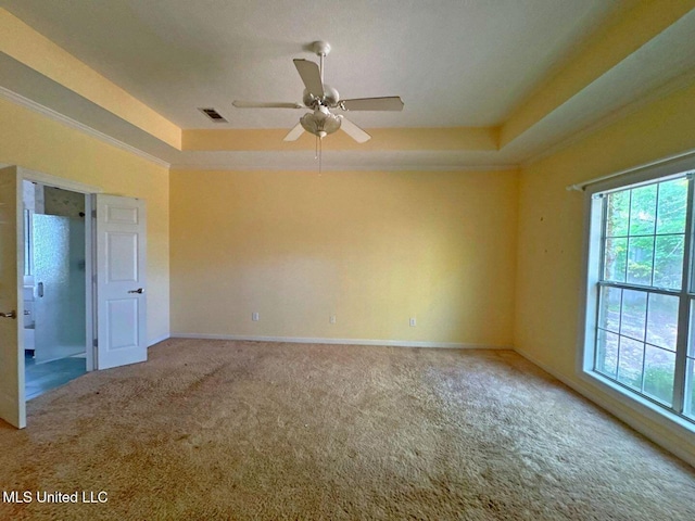 104 Warrior Ln, Clinton, MS 39056 - empty room featuring carpet flooring, a raised ceiling, ceiling fan, baseboards, and crown molding