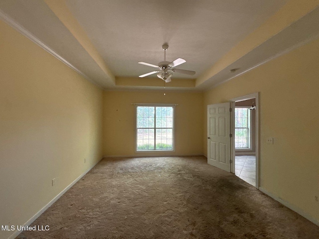 104 Warrior Ln, Clinton, MS 39056 - carpeted empty room featuring a tray ceiling, healthy amount of natural light, and ceiling fan