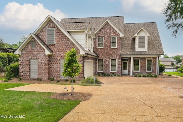 view of front facade featuring a garage and a front lawn