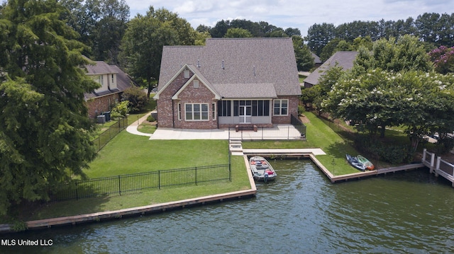 back of property with a yard, central AC, a water view, a patio area, and a sunroom