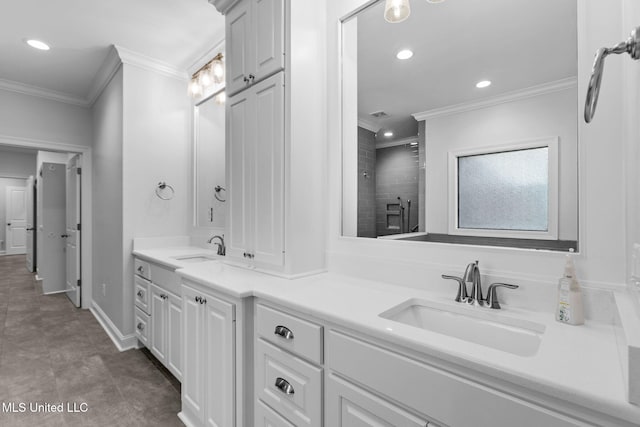 full bath featuring double vanity, ornamental molding, a tile shower, and a sink