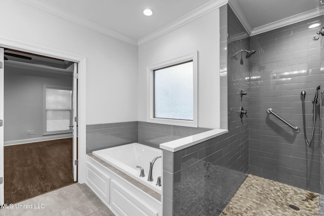 bathroom featuring baseboards, a tile shower, ornamental molding, tile patterned floors, and a bath