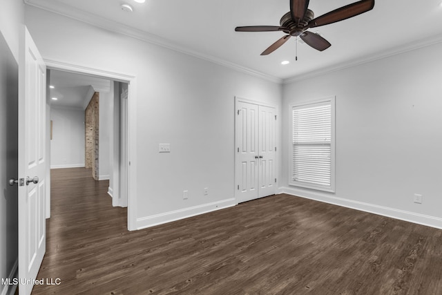 spare room featuring recessed lighting, baseboards, dark wood-type flooring, and ornamental molding