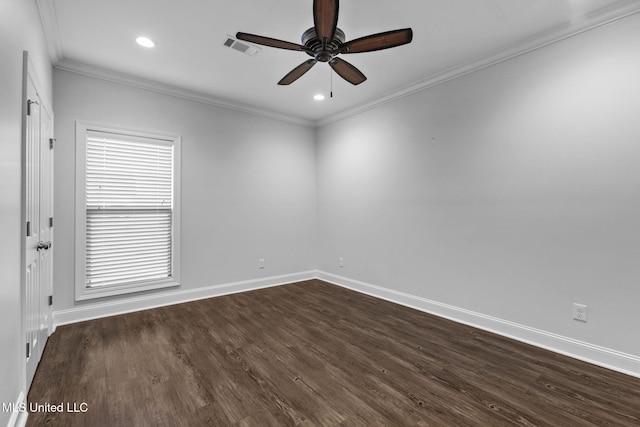 empty room with dark wood finished floors, baseboards, visible vents, and ornamental molding