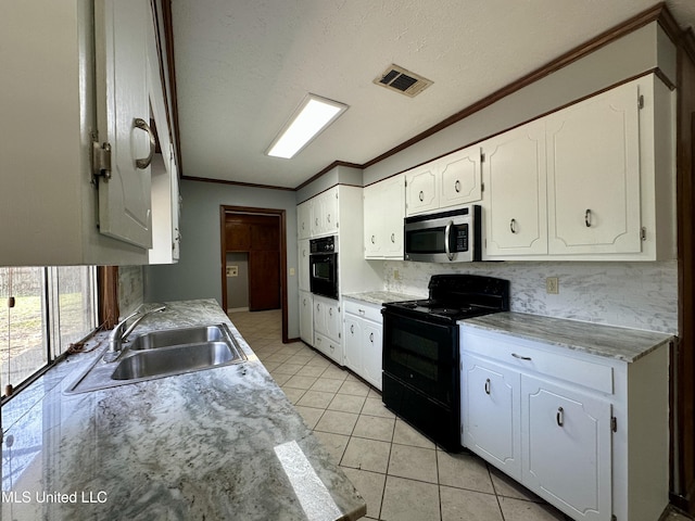 kitchen with ornamental molding, white cabinets, a sink, and black appliances