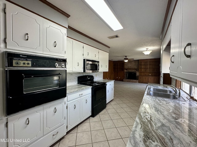 kitchen featuring visible vents, a ceiling fan, open floor plan, black appliances, and light tile patterned flooring