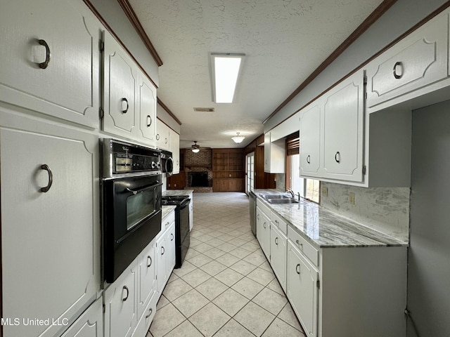 kitchen with visible vents, open floor plan, white cabinets, a textured ceiling, and black appliances