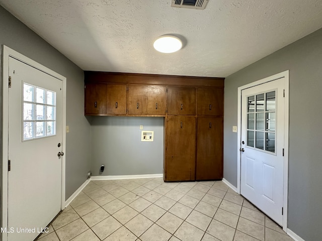 clothes washing area featuring hookup for a washing machine, cabinet space, visible vents, hookup for an electric dryer, and a textured ceiling