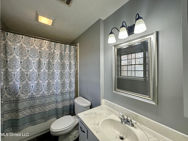 bathroom featuring a shower with curtain, toilet, a textured ceiling, and vanity