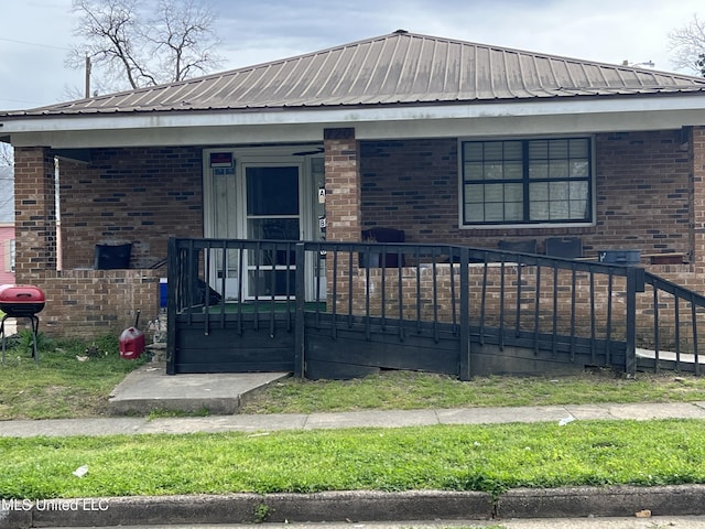 720 Mattingly St, Vicksburg, MS 39180 - exterior space featuring covered porch, brick siding, and metal roof