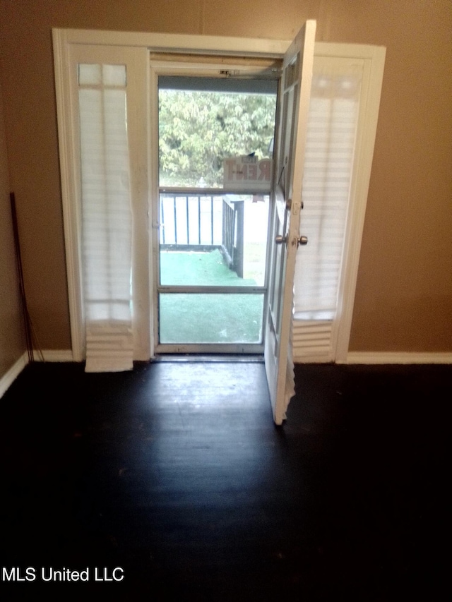 720 Mattingly St, Vicksburg, MS 39180 - doorway featuring baseboards and dark wood-style flooring