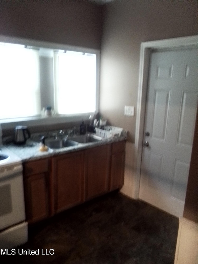 720 Mattingly St, Vicksburg, MS 39180 - interior space featuring brown cabinets, range, and a sink