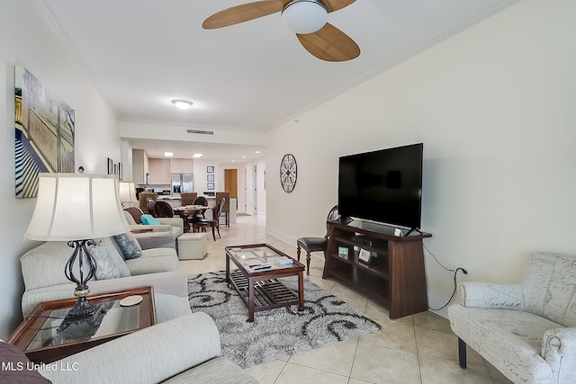 tiled living room with crown molding and ceiling fan