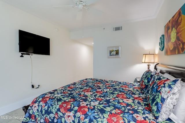 bedroom with ceiling fan and crown molding