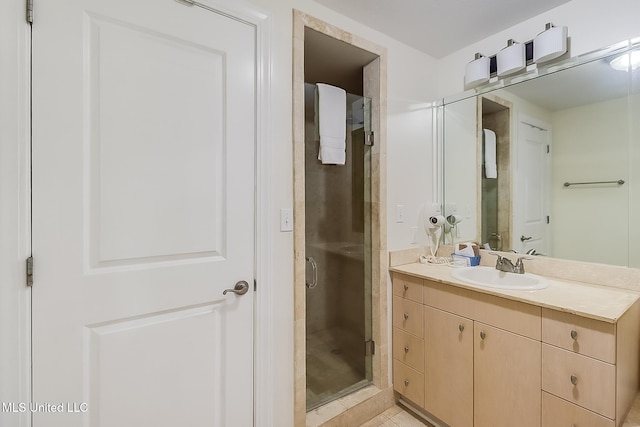 bathroom with tile patterned flooring, vanity, and an enclosed shower