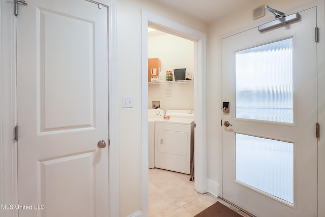 doorway featuring light tile patterned floors and washing machine and clothes dryer