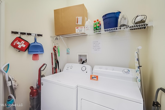 washroom with washing machine and clothes dryer