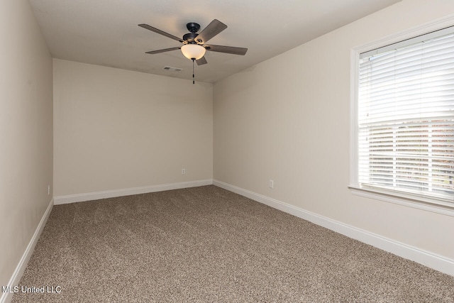 carpeted spare room featuring ceiling fan