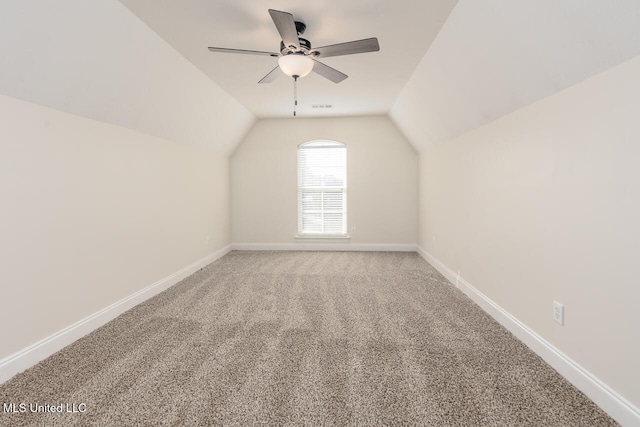 additional living space featuring carpet flooring, ceiling fan, and vaulted ceiling