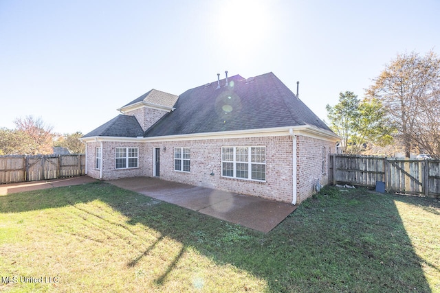 rear view of property featuring a patio area and a yard