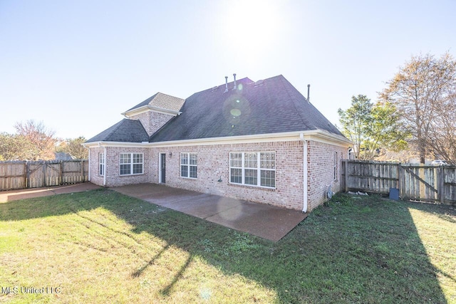 back of property with a lawn and a patio area