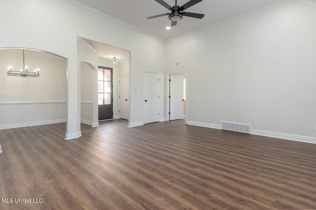 unfurnished living room with crown molding, a towering ceiling, dark hardwood / wood-style floors, and ceiling fan with notable chandelier