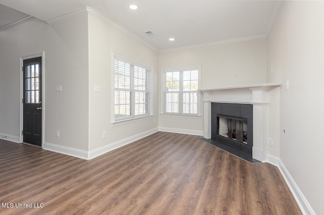 unfurnished living room featuring a tile fireplace, crown molding, and dark hardwood / wood-style flooring