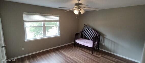 living area with hardwood / wood-style flooring and ceiling fan