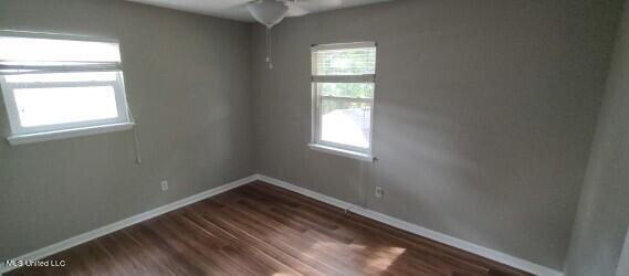 unfurnished room featuring hardwood / wood-style floors and ceiling fan