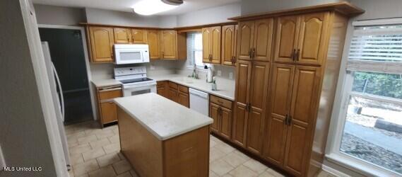 kitchen featuring a center island and white appliances