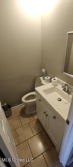 bathroom with vanity, toilet, and tile patterned flooring