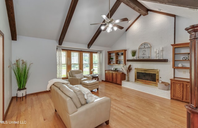 living room with beam ceiling, a fireplace, high vaulted ceiling, and light wood-type flooring