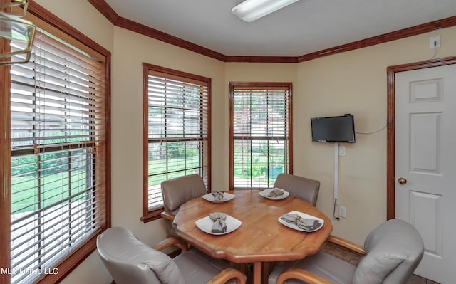 dining space featuring crown molding