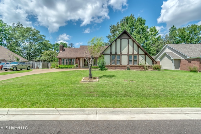 tudor house featuring a front lawn