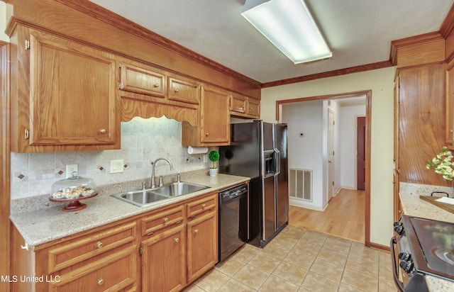 kitchen featuring sink, backsplash, ornamental molding, light tile patterned floors, and black appliances