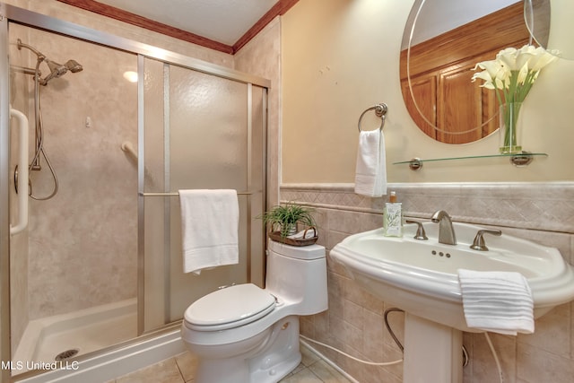 bathroom featuring tile walls, a shower with shower door, toilet, and tile patterned floors