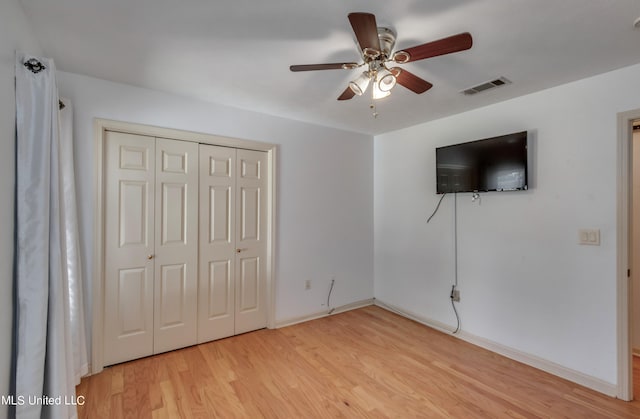 unfurnished bedroom featuring a closet, ceiling fan, and light hardwood / wood-style flooring