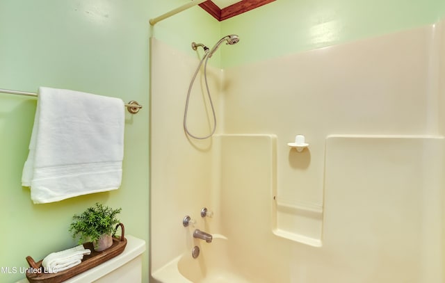 bathroom with shower / washtub combination and toilet