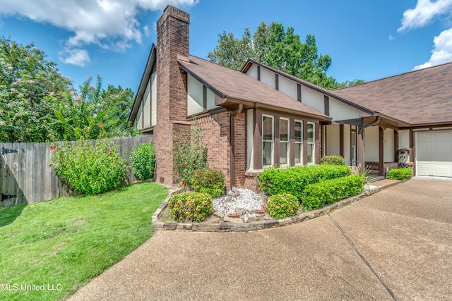 view of front facade with a garage and a front lawn