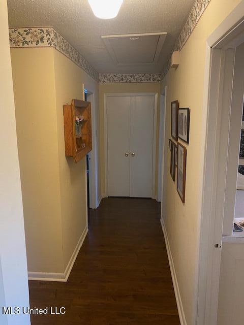 710 Eubanks Rd, Alligator, MS 38720 - hall featuring dark wood-type flooring, baseboards, and a textured ceiling