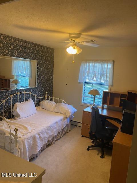 710 Eubanks Rd, Alligator, MS 38720 - bedroom with baseboard heating, an office area, carpet flooring, and ceiling fan