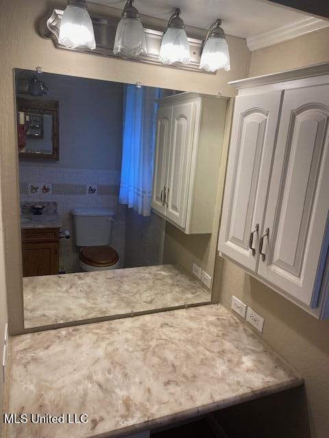 710 Eubanks Rd, Alligator, MS 38720 - bathroom featuring toilet and crown molding