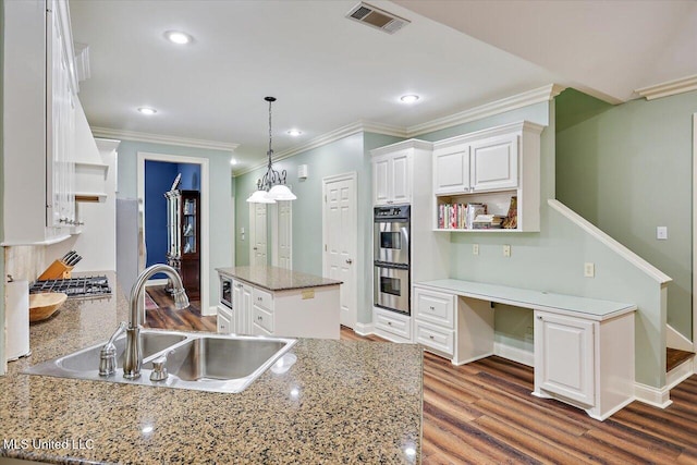 611 Berridge Dr, Ridgeland, MS 39157 - kitchen with a sink, open shelves, double oven, white cabinets, and ornamental molding