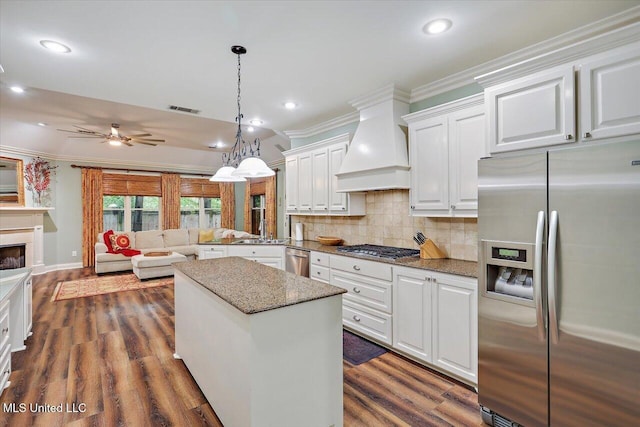 611 Berridge Dr, Ridgeland, MS 39157 - kitchen featuring appliances with stainless steel finishes, crown molding, custom exhaust hood, white cabinets, and a sink