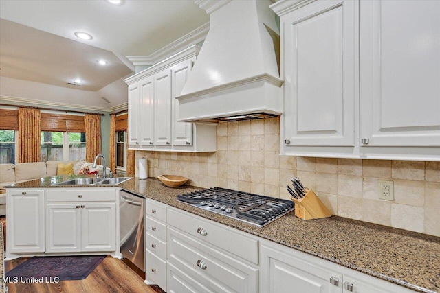 611 Berridge Dr, Ridgeland, MS 39157 - kitchen with custom range hood, appliances with stainless steel finishes, white cabinets, a peninsula, and dark stone countertops