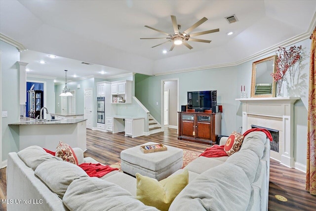 611 Berridge Dr, Ridgeland, MS 39157 - living area with a ceiling fan, crown molding, dark wood-style floors, baseboards, and a fireplace